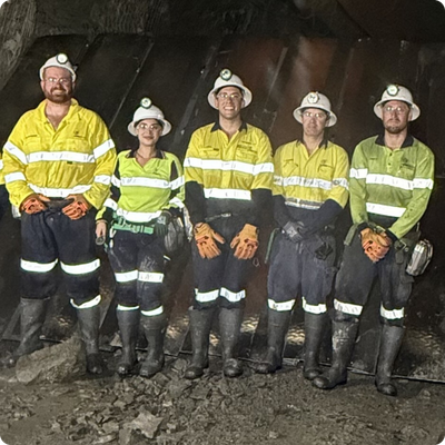 A photo of Monique with her colleagues at a mine