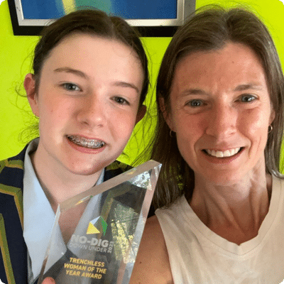 Andrea with her daughter holding the awards